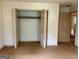 Bedroom with folding closet doors and doorway to another room in home at 807 Oak Bridge Ln, Fayetteville, GA 30214