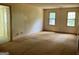 Bedroom featuring two windows for natural light and built-in closet for storage at 807 Oak Bridge Ln, Fayetteville, GA 30214