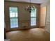 Dining room with large windows, carpet, chandelier, and classic trim details at 807 Oak Bridge Ln, Fayetteville, GA 30214