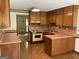 Traditional kitchen featuring wood cabinets, laminate countertops, and tile floors at 807 Oak Bridge Ln, Fayetteville, GA 30214