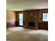 Cozy living room with a brick fireplace, neutral carpet, and natural light at 807 Oak Bridge Ln, Fayetteville, GA 30214