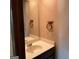 Powder room with patterned wallpaper, single sink, and towel rack at 807 Oak Bridge Ln, Fayetteville, GA 30214