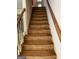 Carpeted stairs with wood railing leads to upper level of house at 807 Oak Bridge Ln, Fayetteville, GA 30214