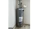Classic Rheem water heater with visible pipes, pressure tank, and gas valve in a corner at 807 Oak Bridge Ln, Fayetteville, GA 30214