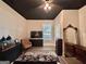 Spacious bedroom accented by a dark ceiling, neutral decor, and an ornate antique mirror at 6192 Collins Ne St, Covington, GA 30014