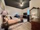 Bright bedroom featuring a bold ceiling, stylish rug, and a mix of modern and vintage furniture at 6192 Collins Ne St, Covington, GA 30014