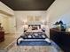 Cozy bedroom showcasing a statement rug, warm lighting, and a modern black ceiling at 6192 Collins Ne St, Covington, GA 30014