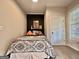 Bright bedroom with wooden floors, a black accent wall, and a bed with a patterned bedspread at 6192 Collins Ne St, Covington, GA 30014