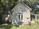 Back exterior with a storage unit and a white door with glass panes to the main house at 6192 Collins Ne St, Covington, GA 30014