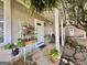 Covered front porch with seating, plants, and a view of the front yard and side yard at 6192 Collins Ne St, Covington, GA 30014