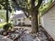 Charming home with a large tree, stone pathway, and inviting front porch with furniture at 6192 Collins Ne St, Covington, GA 30014