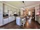 Open kitchen with an island, granite countertops, and stainless steel appliances, seamlessly connecting to the living space at 6192 Collins Ne St, Covington, GA 30014