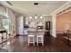 Modern kitchen features a center island with seating, stainless steel appliances, and abundant natural light at 6192 Collins Ne St, Covington, GA 30014