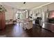 An open kitchen with white cabinets, stainless steel appliances, and a kitchen island with barstool seating at 6192 Collins Ne St, Covington, GA 30014