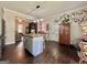 The open-concept kitchen boasts an island with seating and views into the living area at 6192 Collins Ne St, Covington, GA 30014