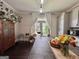 Bright kitchen with a large island, pendant lighting, flowers, and a wall of plant decorations at 6192 Collins Ne St, Covington, GA 30014