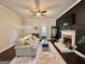 Bright living room with fireplace, dark accent wall, and hardwood floors, exuding modern elegance at 6192 Collins Ne St, Covington, GA 30014