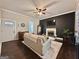 Inviting living room features a fireplace, dark accent wall, wood floors, and comfortable seating area at 6192 Collins Ne St, Covington, GA 30014