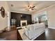 Cozy living room with a fireplace, dark wood flooring, neutral walls and a ceiling fan at 6192 Collins Ne St, Covington, GA 30014