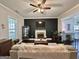 Cozy living room with a fireplace, dark wood flooring, neutral walls and a ceiling fan at 6192 Collins Ne St, Covington, GA 30014