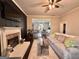 View of the cozy living room featuring a fireplace, comfortable seating, and access to kitchen at 6192 Collins Ne St, Covington, GA 30014