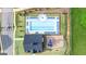 Aerial view of community pool, playground, clubhouse, and surrounding landscape at 687 Edgar St # 83, Hampton, GA 30228