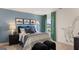 This bedroom features a blue accent wall, a comfortable bed, and unique dinosaur decor at 687 Edgar St # 83, Hampton, GA 30228