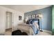 Well-lit bedroom with a blue accent wall, carpet floors, and pictures hanging above the bed at 687 Edgar St # 83, Hampton, GA 30228