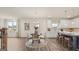 Inviting dining area with modern lighting, wood floors, and a view into the stylish kitchen at 687 Edgar St # 83, Hampton, GA 30228