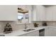 Bright kitchen features a double sink, white cabinetry, and a large window with natural light at 687 Edgar St # 83, Hampton, GA 30228