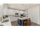 Stylish kitchen with stainless steel appliances, white cabinets, ample counter space and island seating at 687 Edgar St # 83, Hampton, GA 30228