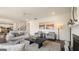 Spacious living room featuring a fireplace, cozy seating, and seamless transition to the dining area at 687 Edgar St # 83, Hampton, GA 30228