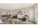 This living room features natural light, hardwood floors, and a bar area in the background at 687 Edgar St # 83, Hampton, GA 30228