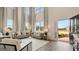Bright and airy living room with high ceilings, large windows, and an open doorway showcases abundant natural light at 687 Edgar St # 83, Hampton, GA 30228