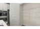 Walk-in pantry featuring white wire shelving for organized storage in this modern home at 687 Edgar St # 83, Hampton, GA 30228