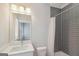 Gray bathroom with a shower and a vanity with large mirror at 1100 Thomas St, Woodstock, GA 30188