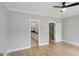 Neutral bedroom featuring hardwood flooring and two entryways at 1100 Thomas St, Woodstock, GA 30188
