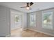Cozy bedroom with hardwood floors, two windows, and a ceiling fan at 1100 Thomas St, Woodstock, GA 30188