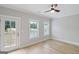Bedroom with hardwood floors, two windows and access to a balcony at 1100 Thomas St, Woodstock, GA 30188