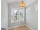 Bright bedroom with hardwood floors and a unique chandelier at 1100 Thomas St, Woodstock, GA 30188