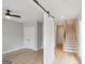 Bright entryway featuring hardwood floors, a sliding barn door, and stairs at 1100 Thomas St, Woodstock, GA 30188