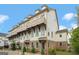 Townhouse exterior showcasing brick accents, balconies, and manicured landscaping at 1100 Thomas St, Woodstock, GA 30188