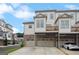 Exterior of new townhomes showing ground level garages and a sidewalk at 1100 Thomas St, Woodstock, GA 30188