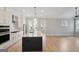 Open-concept kitchen with an island, stainless steel appliances, and hardwood floors at 1100 Thomas St, Woodstock, GA 30188