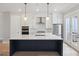 Modern kitchen with a large island, stainless steel appliances, and pendant lights at 1100 Thomas St, Woodstock, GA 30188