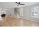 Bright living room with staircase, hardwood floors, and open access to kitchen at 1100 Thomas St, Woodstock, GA 30188