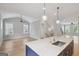 Bright living room with hardwood floors and a kitchen island at 1100 Thomas St, Woodstock, GA 30188