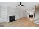 Open-concept living room with a fireplace, built-in shelving, and hardwood flooring at 1100 Thomas St, Woodstock, GA 30188