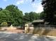 View of the home's brick paved driveway and perimeter walls with accents and lush landscaping at 5523 Bahia Mar Cir, Stone Mountain, GA 30087