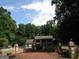 Beautiful home with brick courtyard, retaining wall with pillar accents, and lush surrounding landscape at 5523 Bahia Mar Cir, Stone Mountain, GA 30087